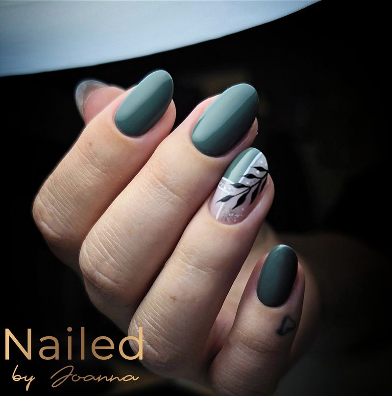 Dark green nails with a painted leaf